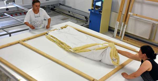 Placing the duvet on the frame.
