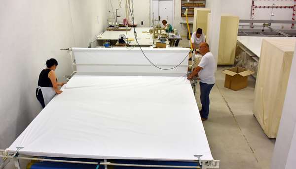 Cutting the fabric in successive layers.